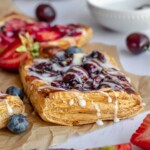 A blueberry cream cheese danish topped with vanilla icing.