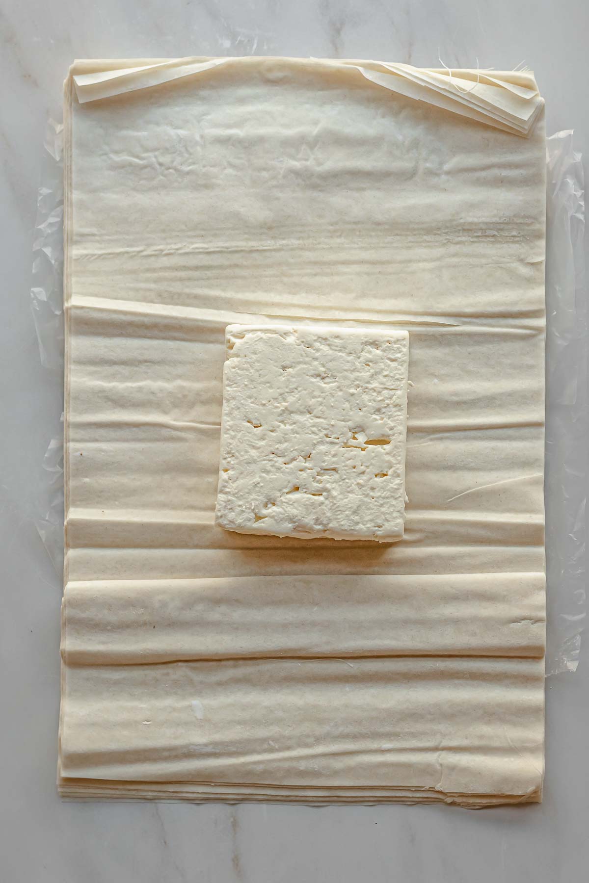 A block of feta cheese on phyllo pastry.