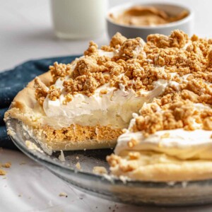 Amish peanut butter pie in a pie dish with a slice removed.
