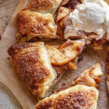 Sliced apple galette with ice cream on top.