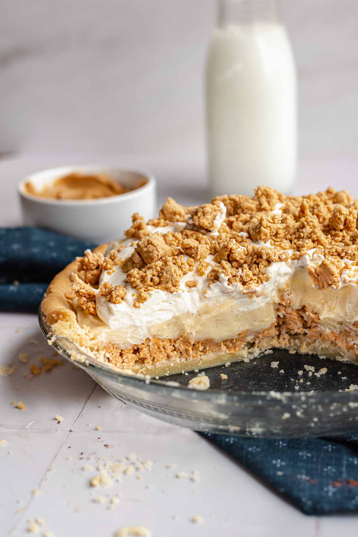 Amish peanut butter pie in a pie dish with slices removed.