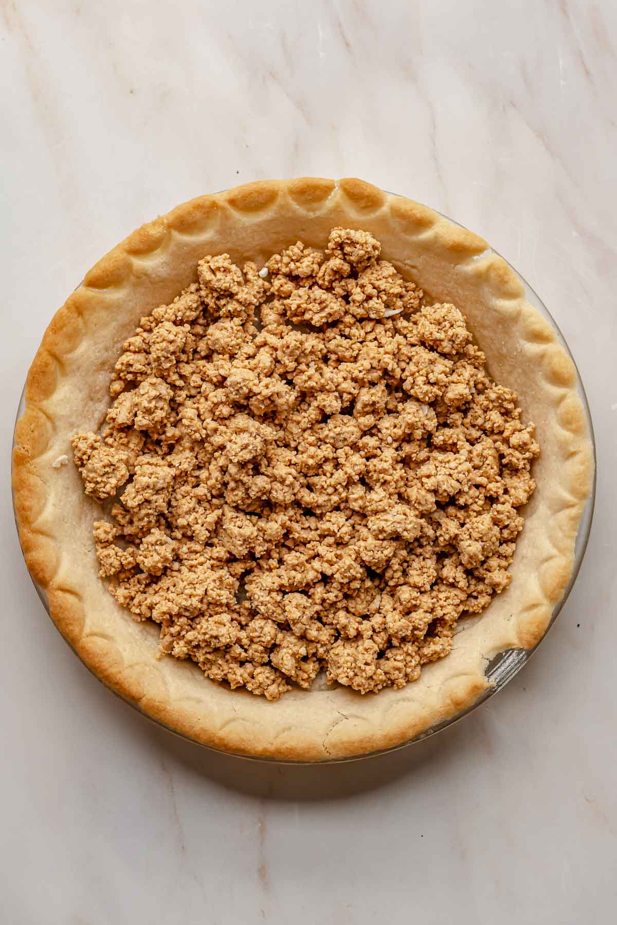 Peanut butter crumbles in a pie curst.