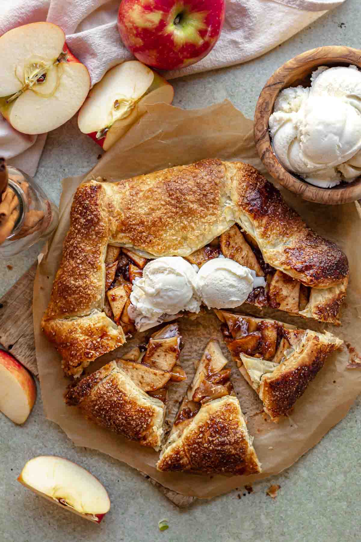 Sliced apple galette with ice cream on top.