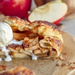 Apple tart with a scoop of ice cream melting over the sides.