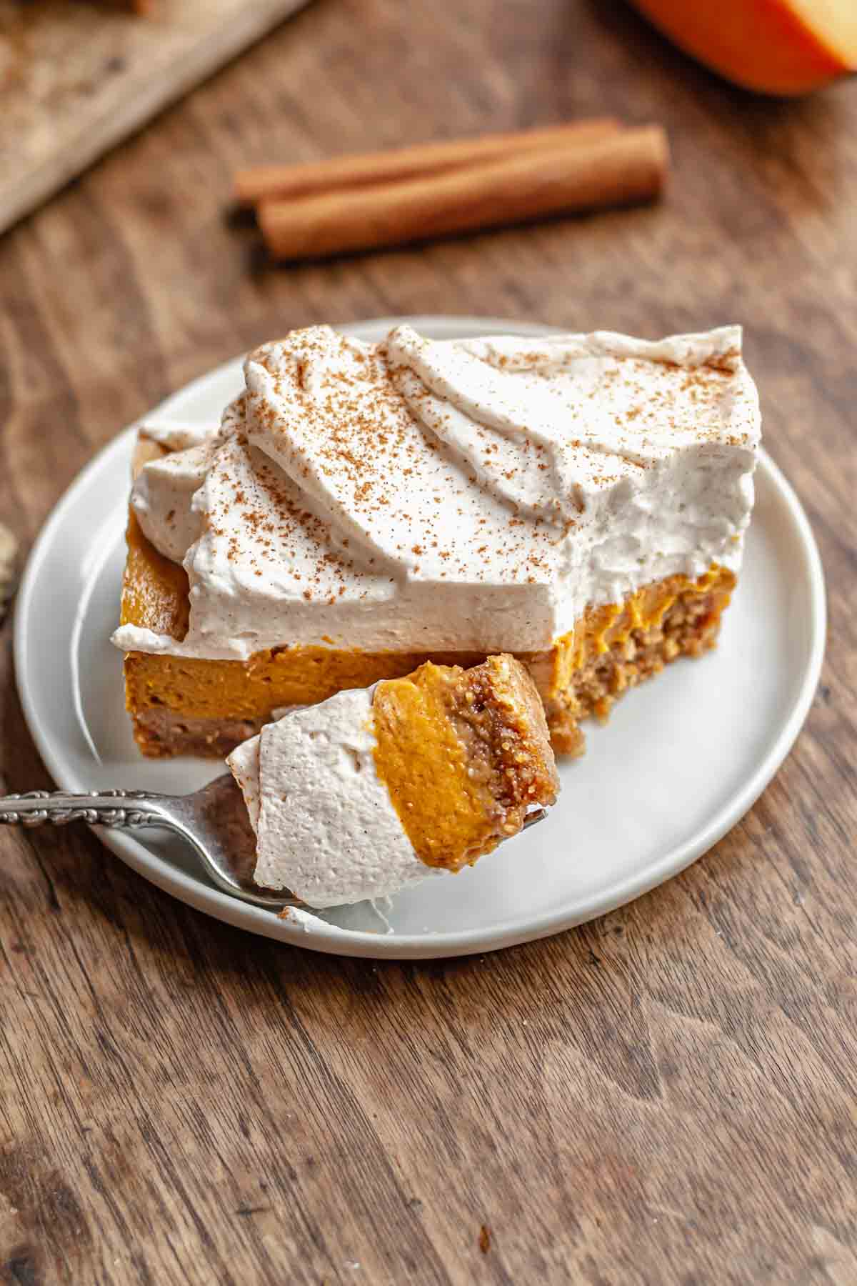 Sweet potato pie bar on a plate with a bite removed.