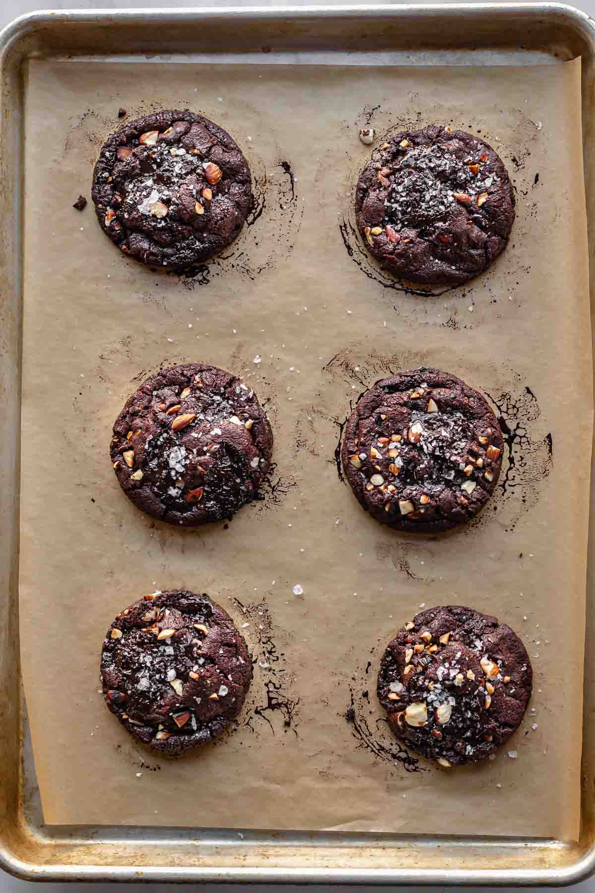 Baked chocolate almond cookies on a cookie sheet.