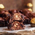 Brownie split in half and stacked. The center exposes the Ferrero rocher.