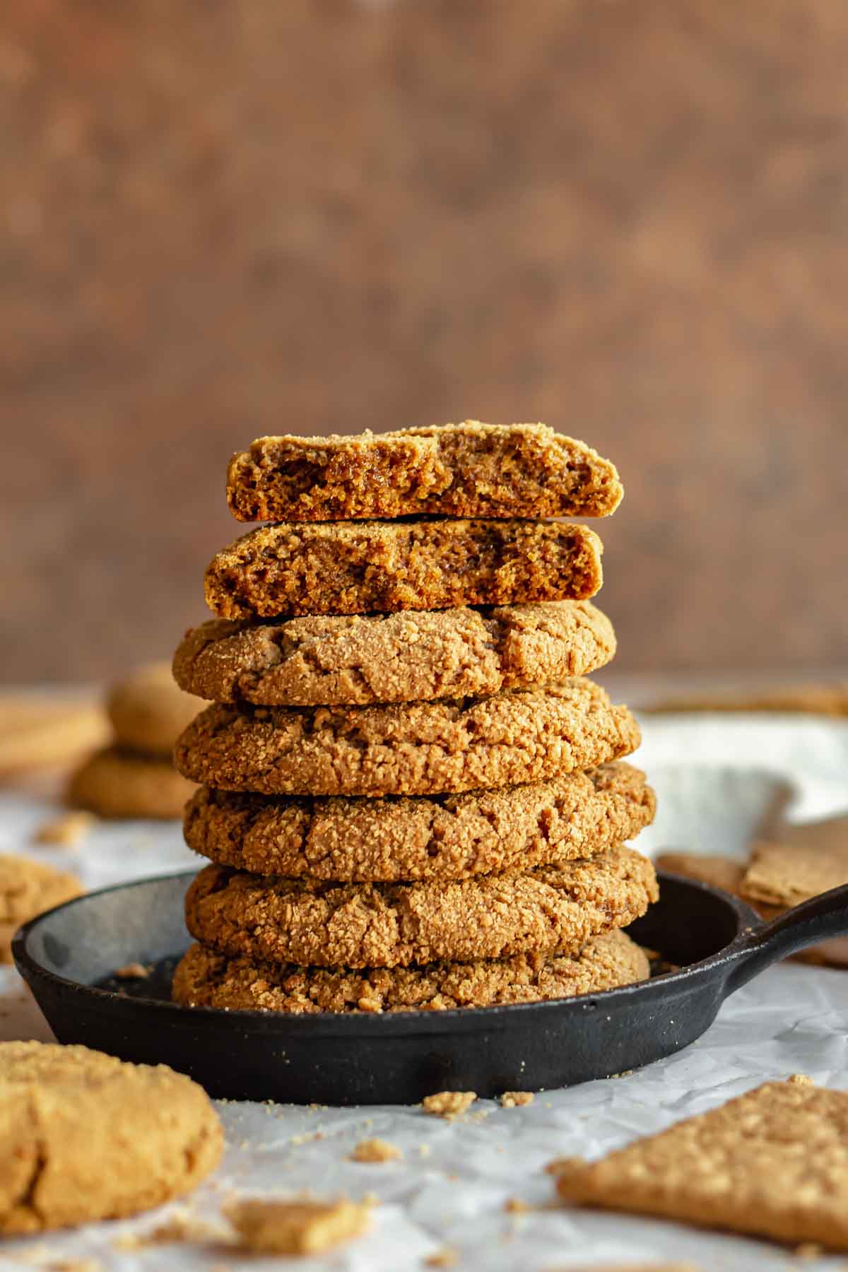 A stack of graham cracker cookies. The top two are broken open.