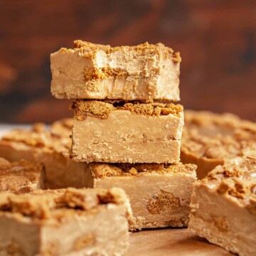 Stack of Biscoff fudge. The top has a bite removed.