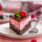 Piece of raspberry mousse cake on a plate.