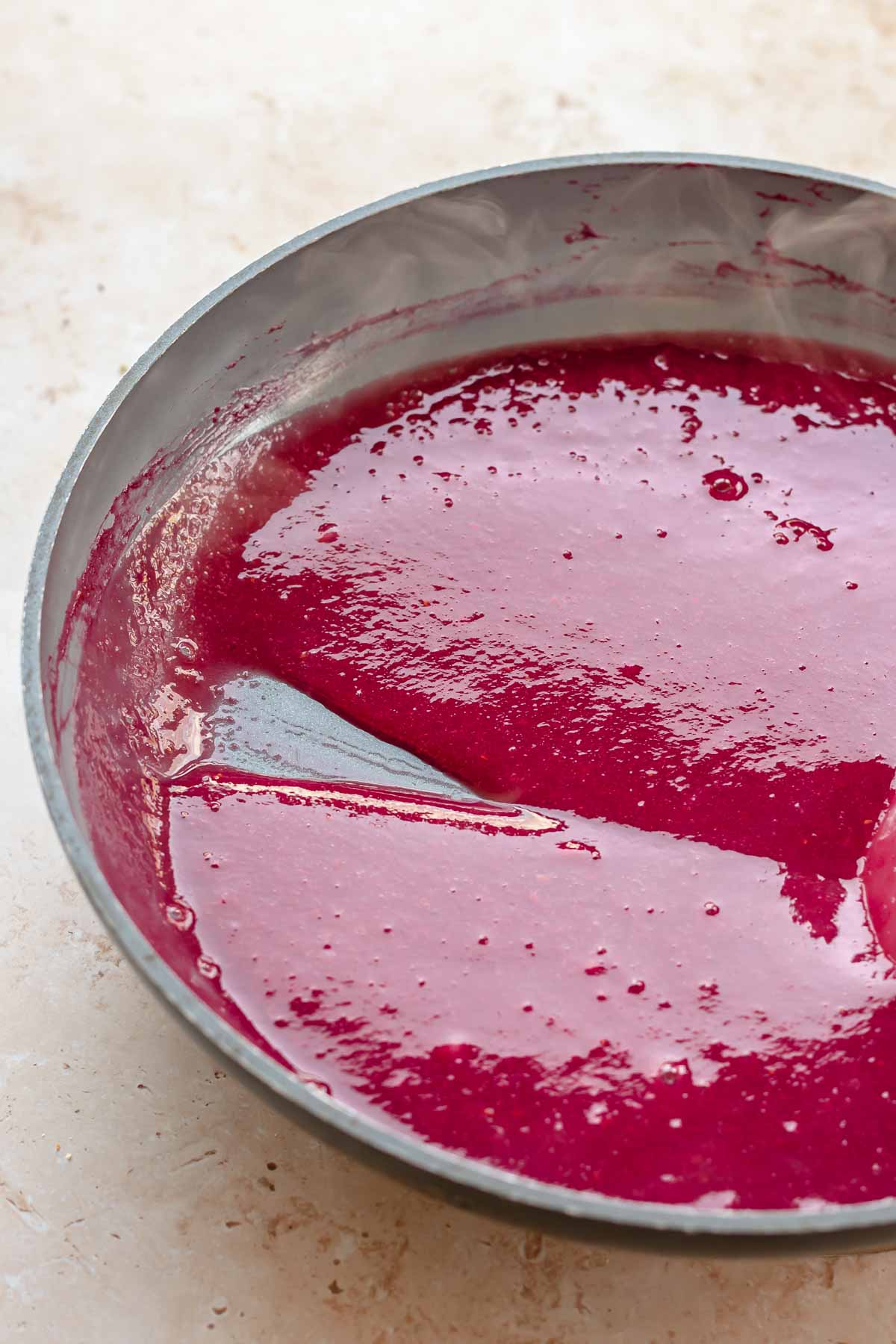 Raspberry puree in a pan.