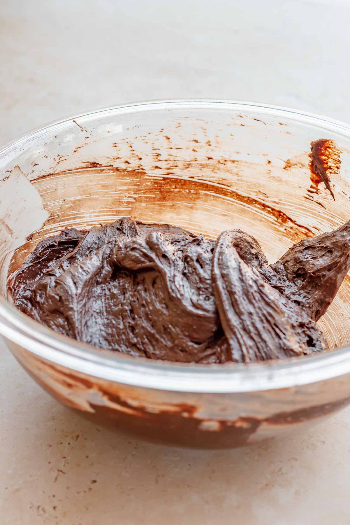 Thick chocolate cake batter in a bowl.