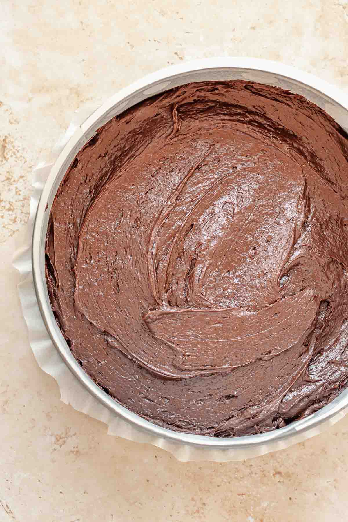 Chocolate cake batter in a springform pan pre-baked.