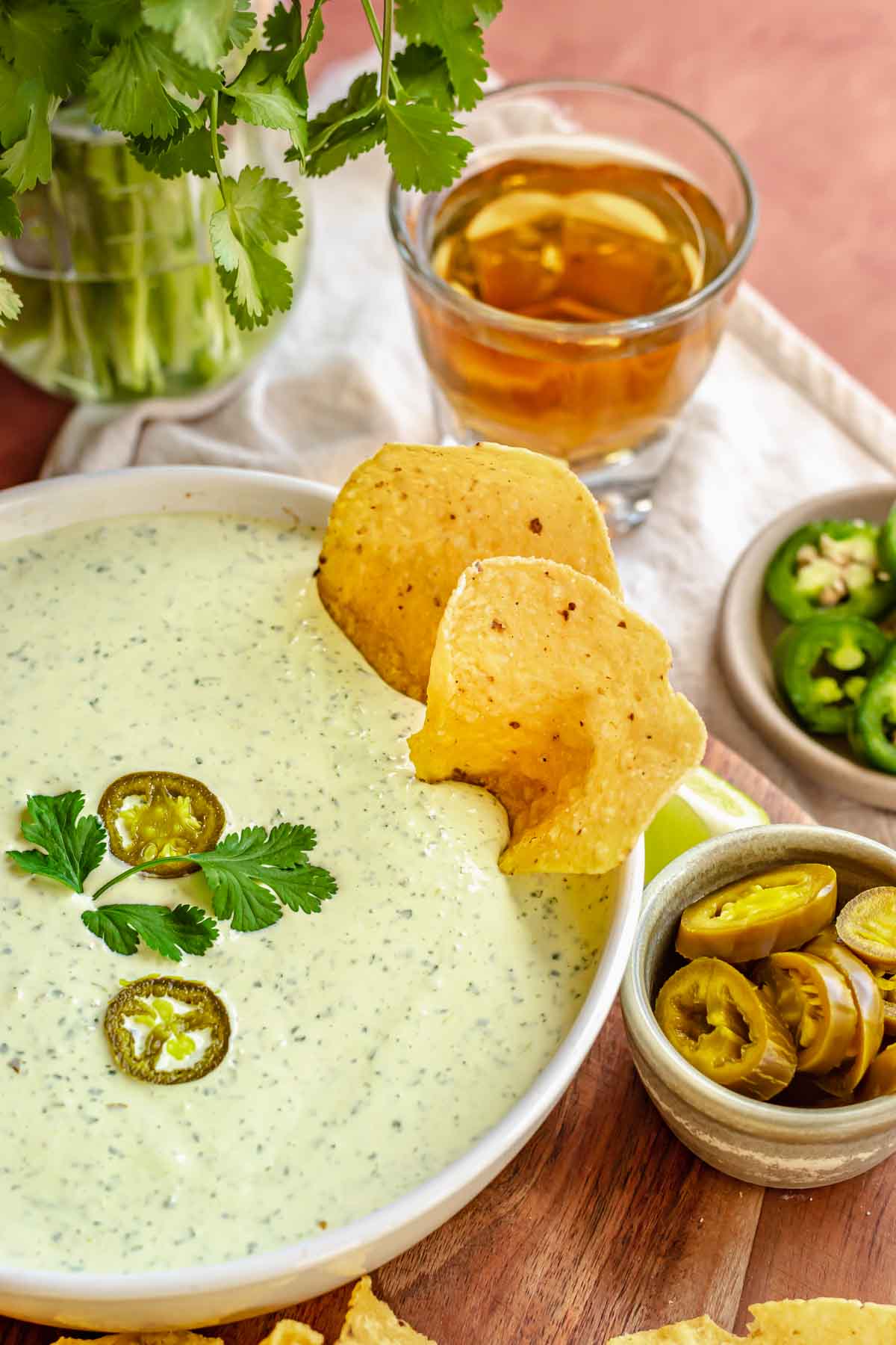 Jalapeno ranch dip in a bowl with chips sitting in it.