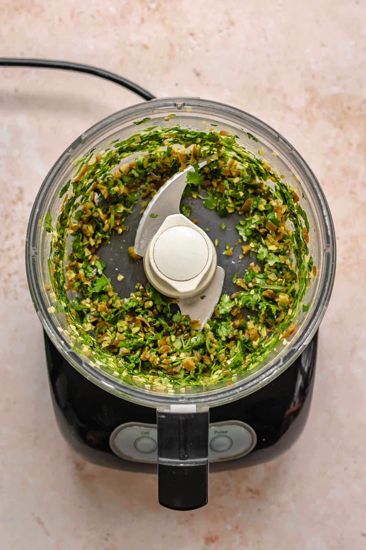 Finely chopped cilantro and jalapeños in a food processor.