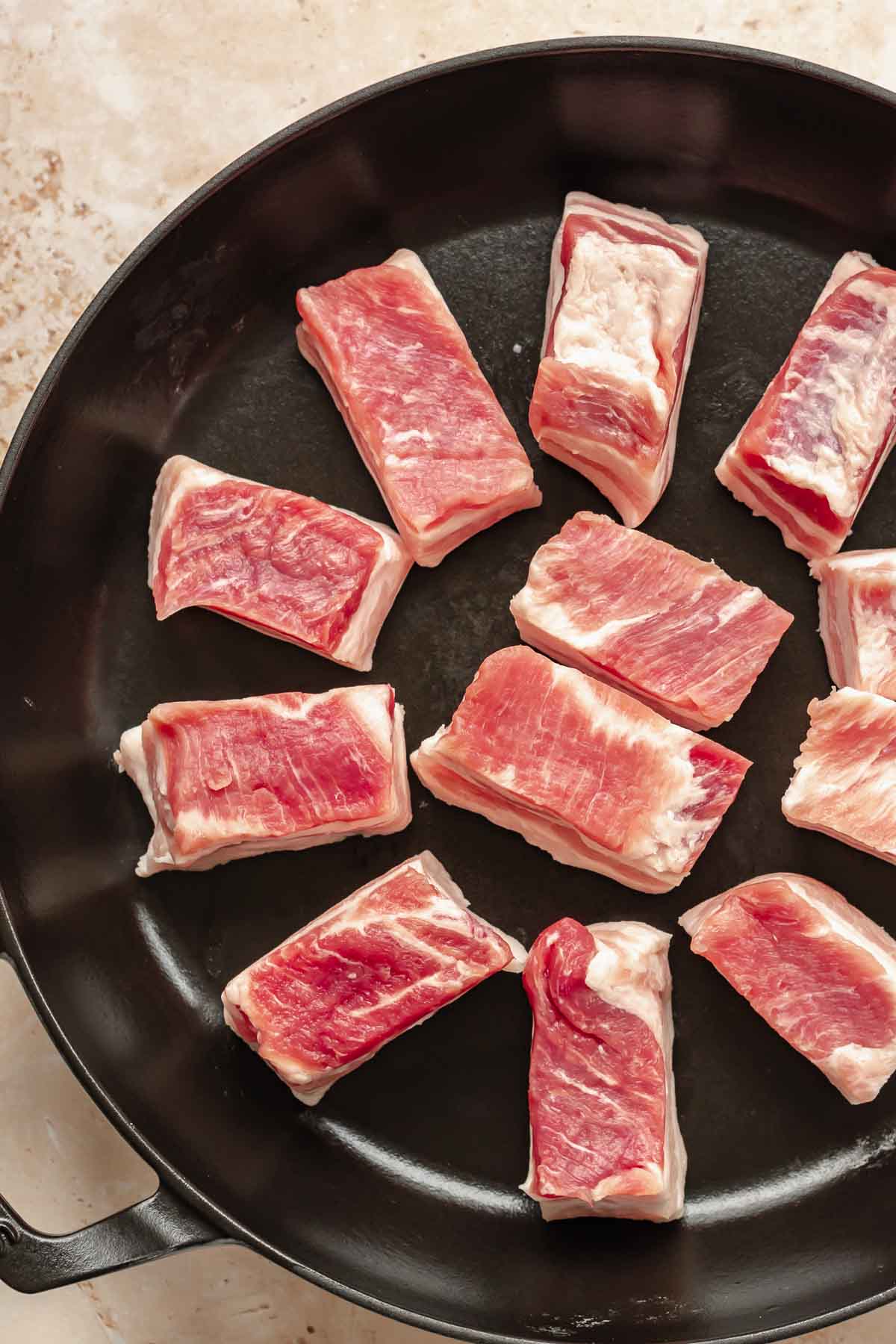 Cut pork belly in a pan.