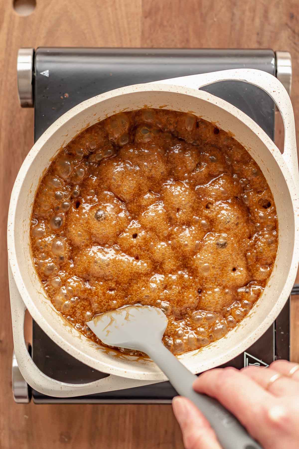 Bubbling butter and sugar in a pan.