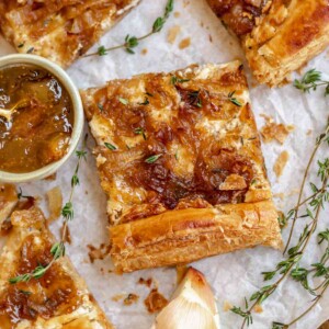 Slice of onion and cheese tart with fig jam.