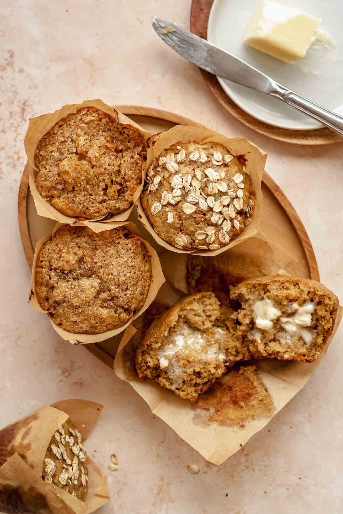 All-bran muffins on a plate. One is broken open.