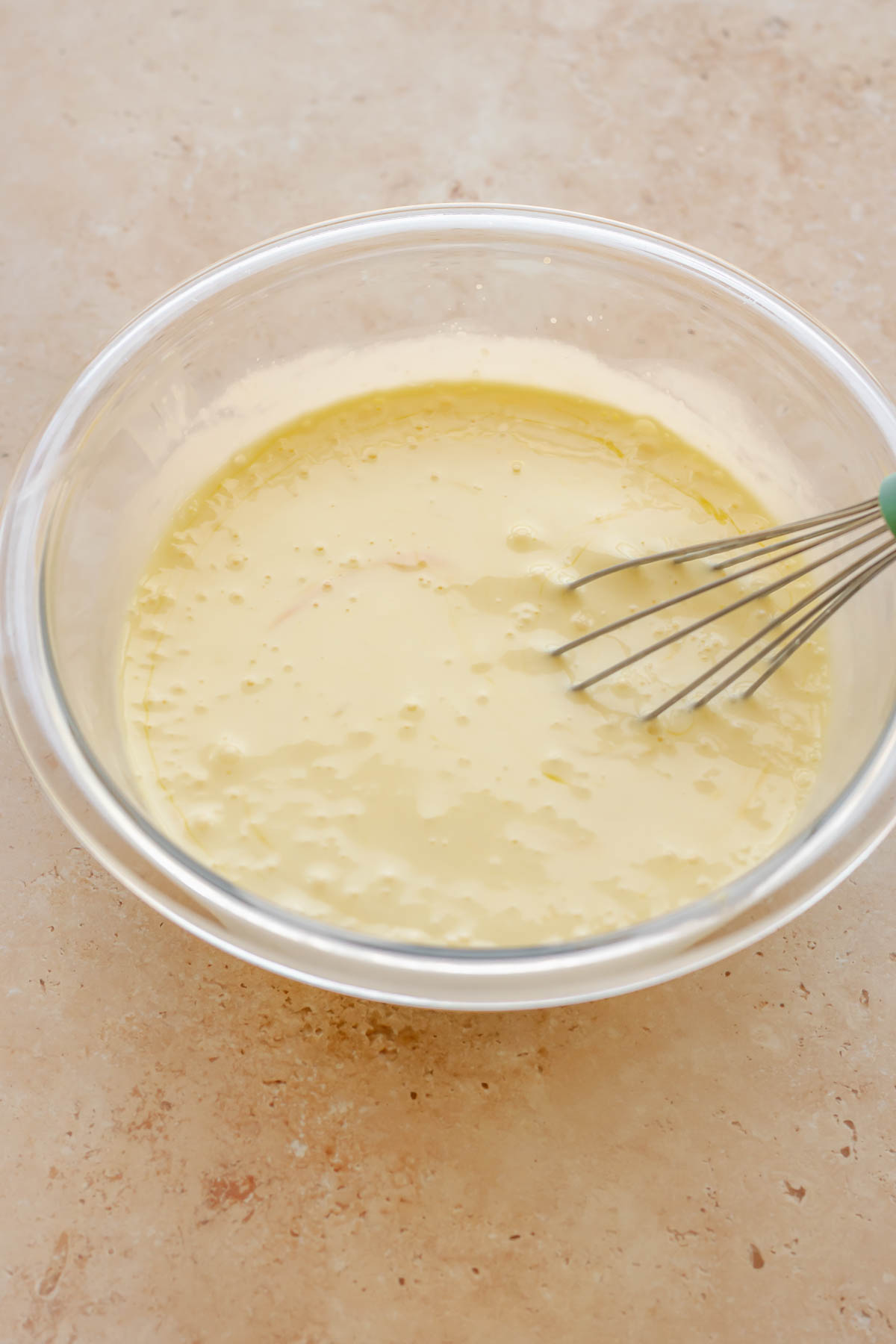 Egg custard whisked in a mixing bowl.