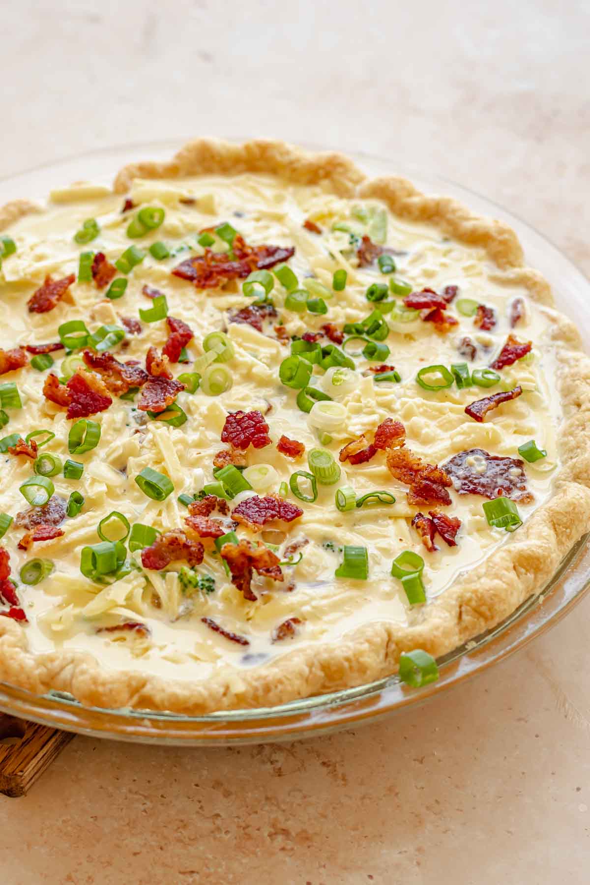 Pre-baked quiche topped with scallions.