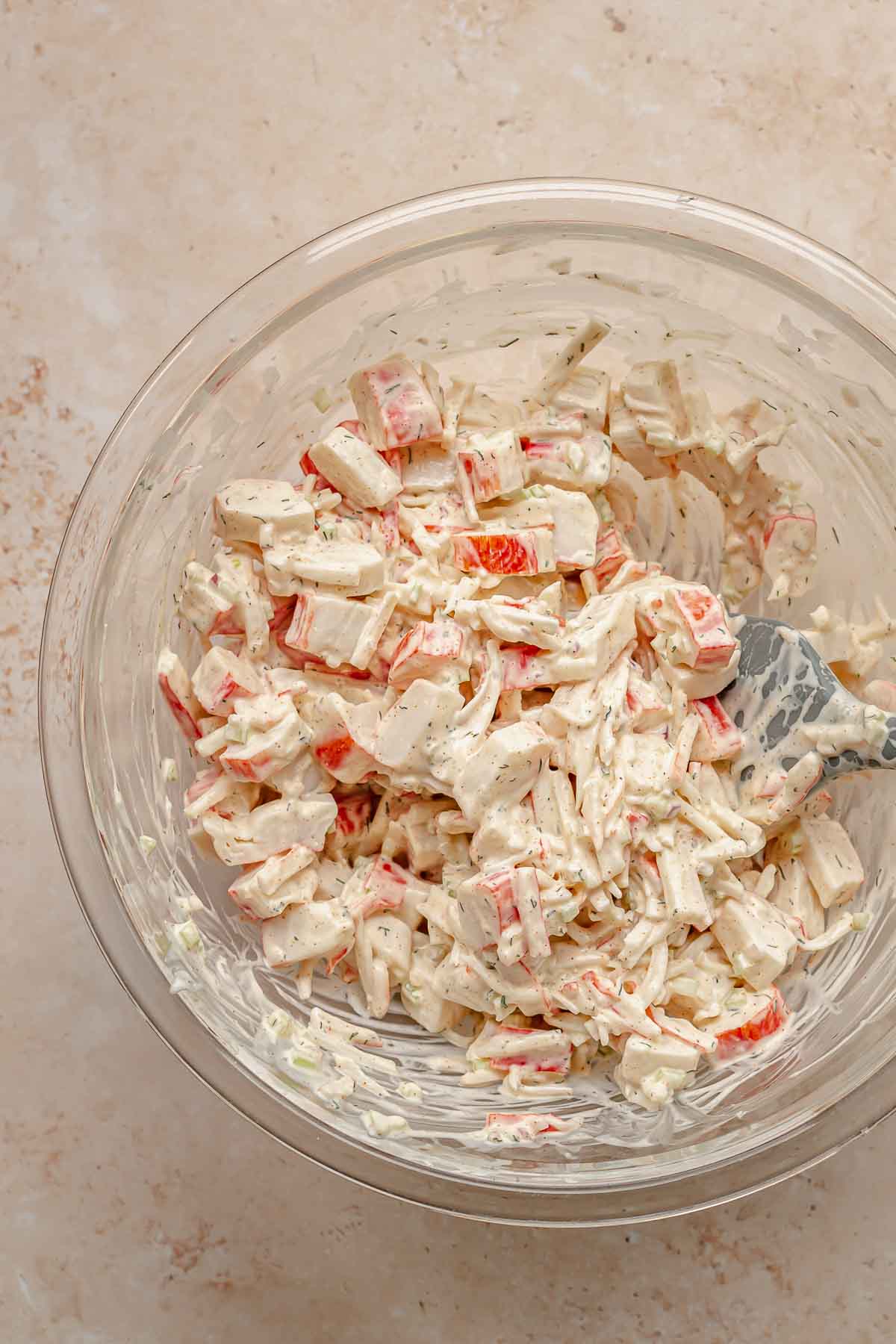Imitation crab and dressing mixed in a bowl.