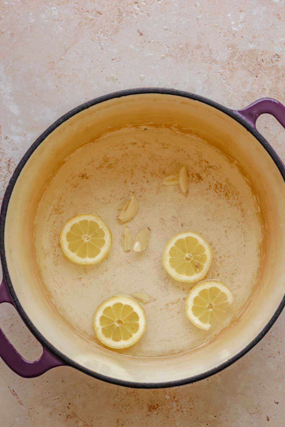 Lemon and garlic in water in a pot.