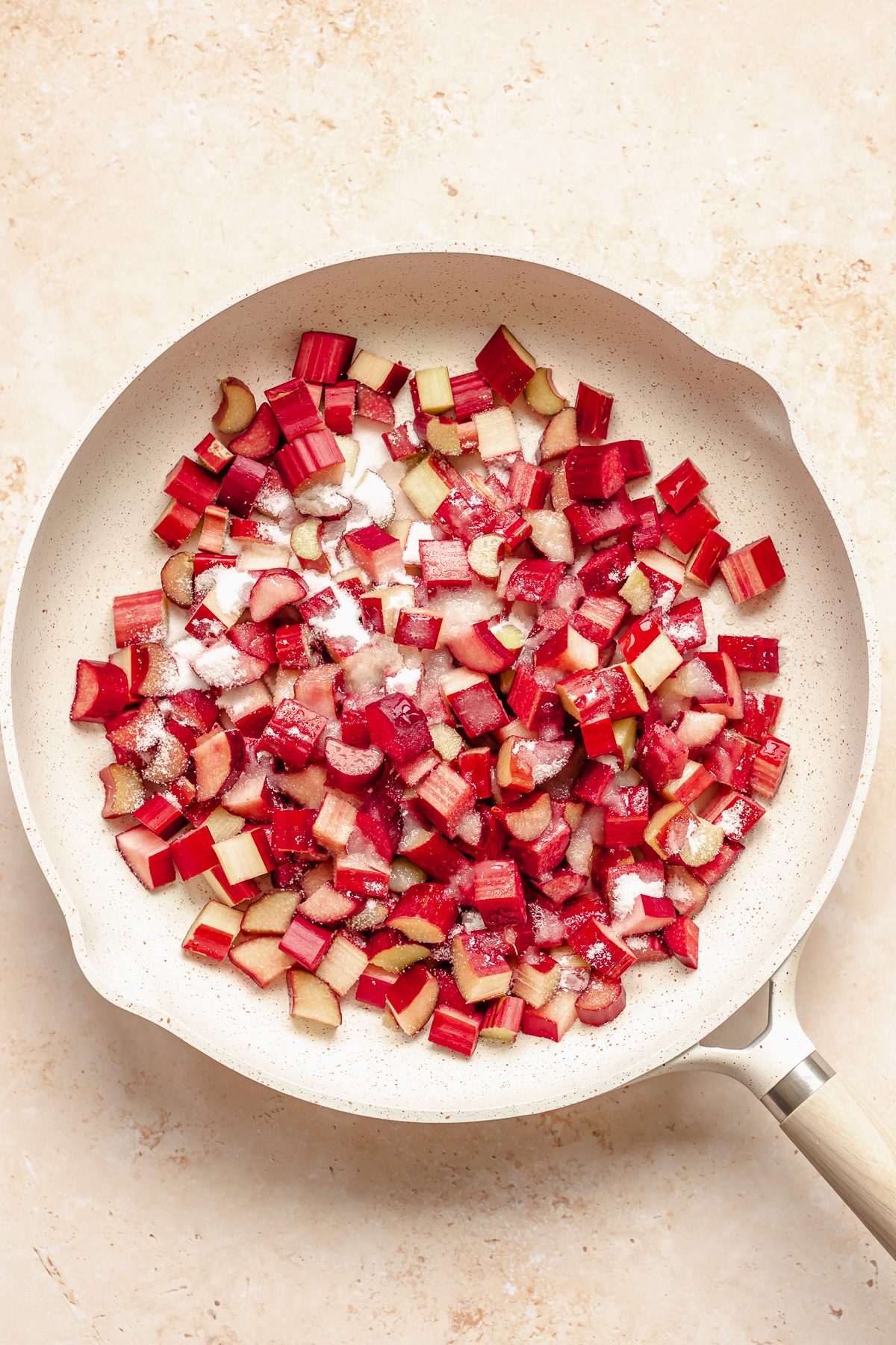 Rhubarb and sugar in a frying pan.