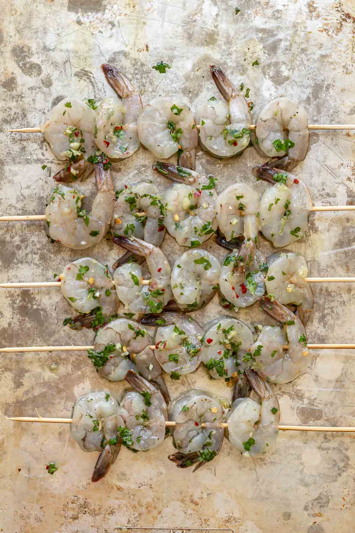 Marinated raw shrimp on skewers.