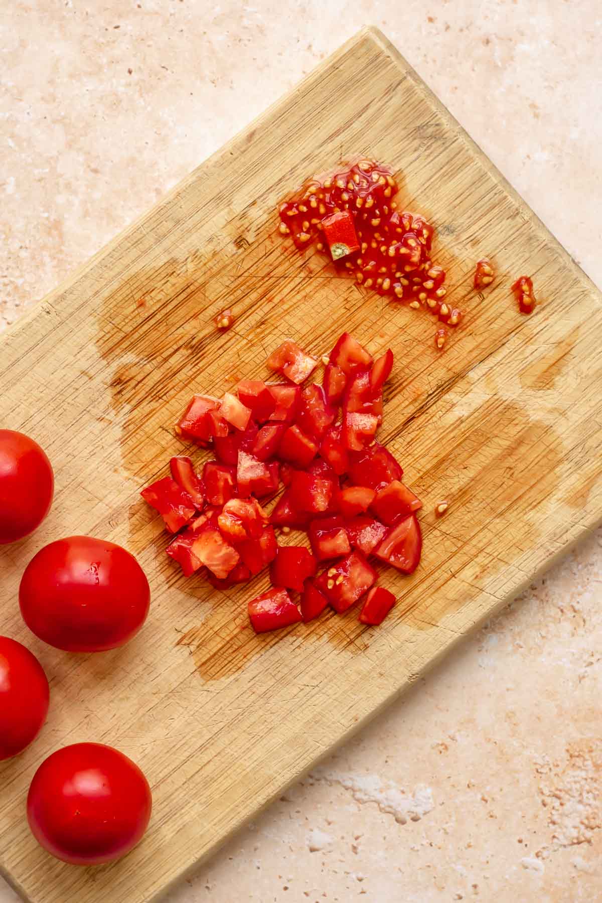 Tomatoes chopped on a board.