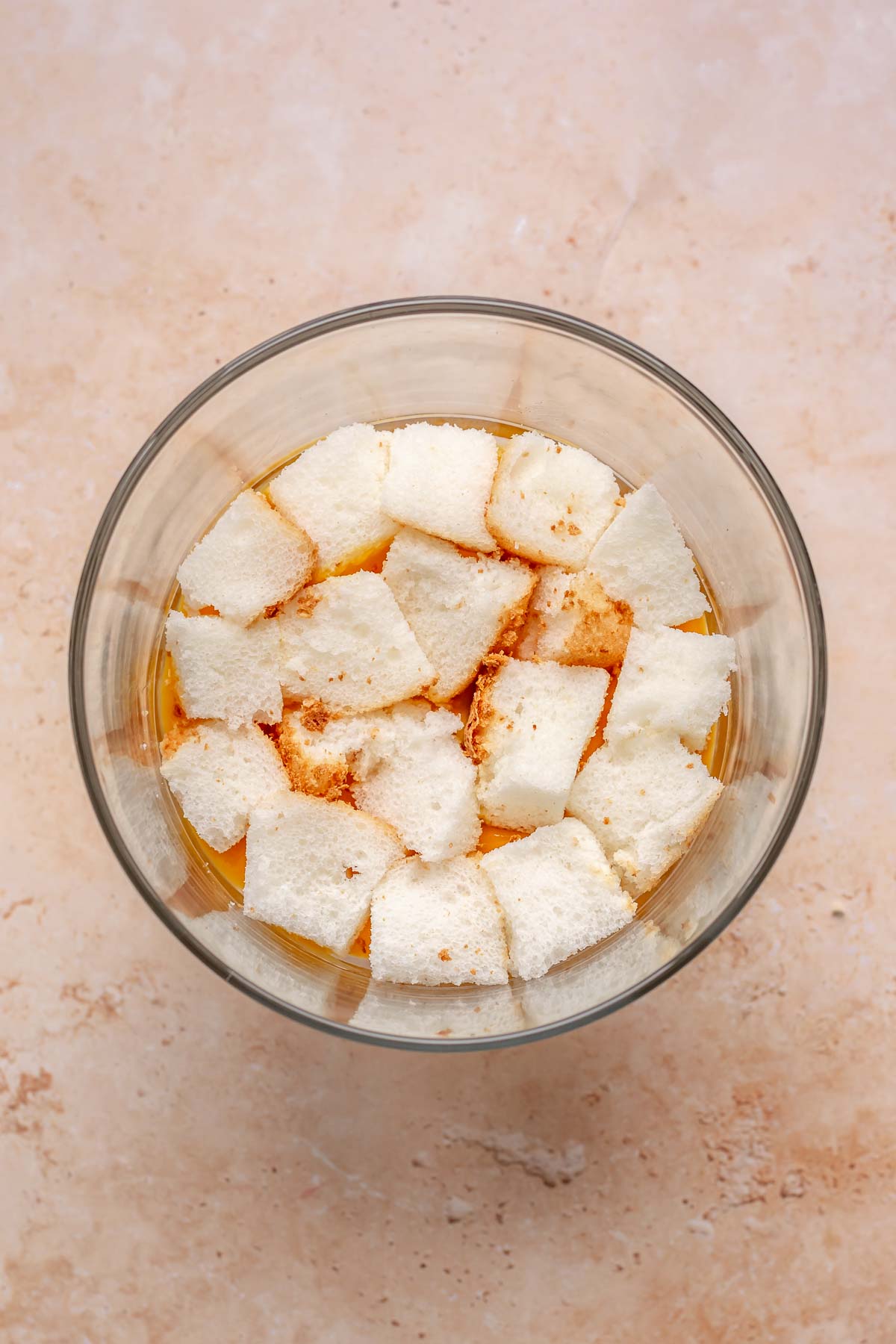 Angel food cake in a trifle bowl in a layer.