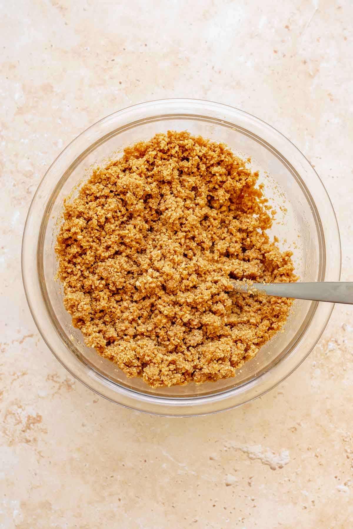 Moistened graham cracker crumbs in a bowl.