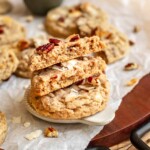 A stack of coconut pecan cookies. The top two are broken in half.