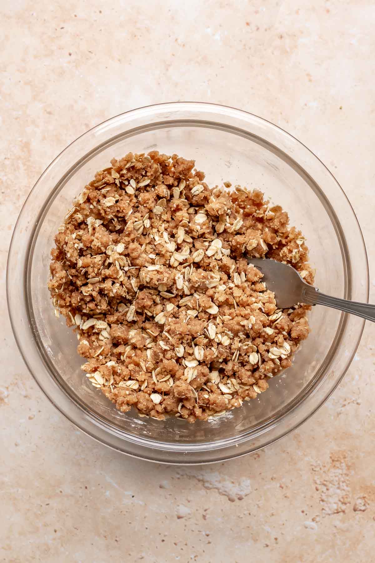 Crumble topping mixed in a bowl with a fork.