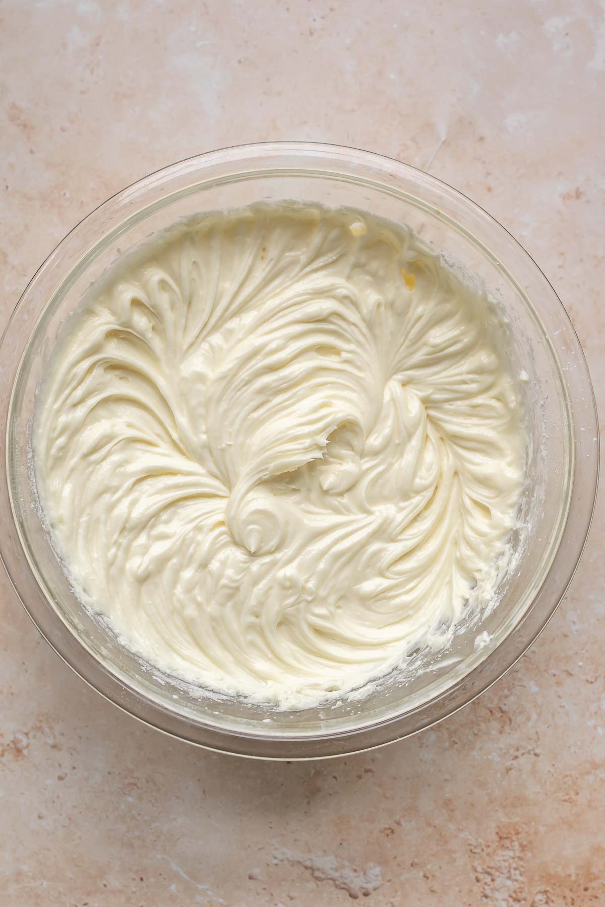 Cream cheese batter whisked in a mixing bowl.