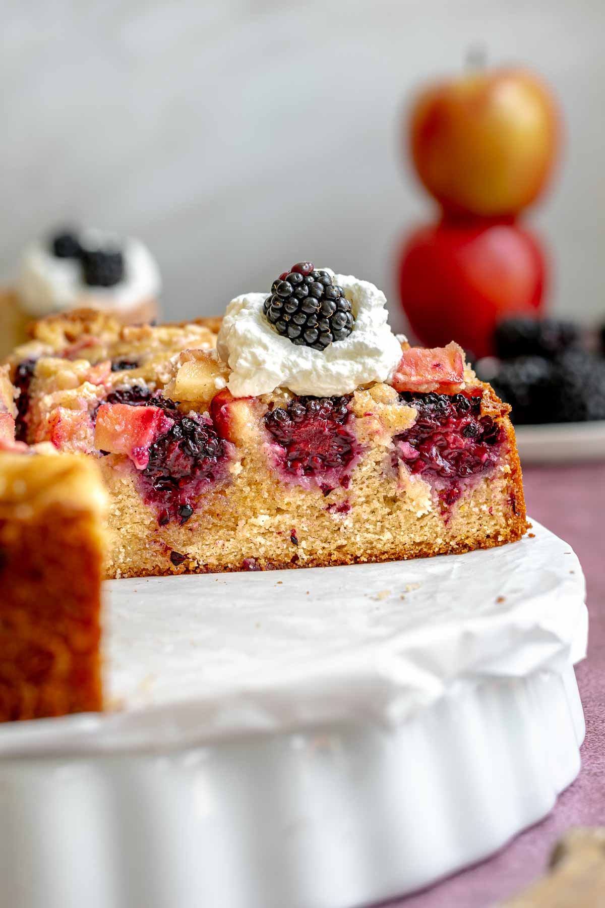 Cut blackberry apple cake on a platter to expose the inside.