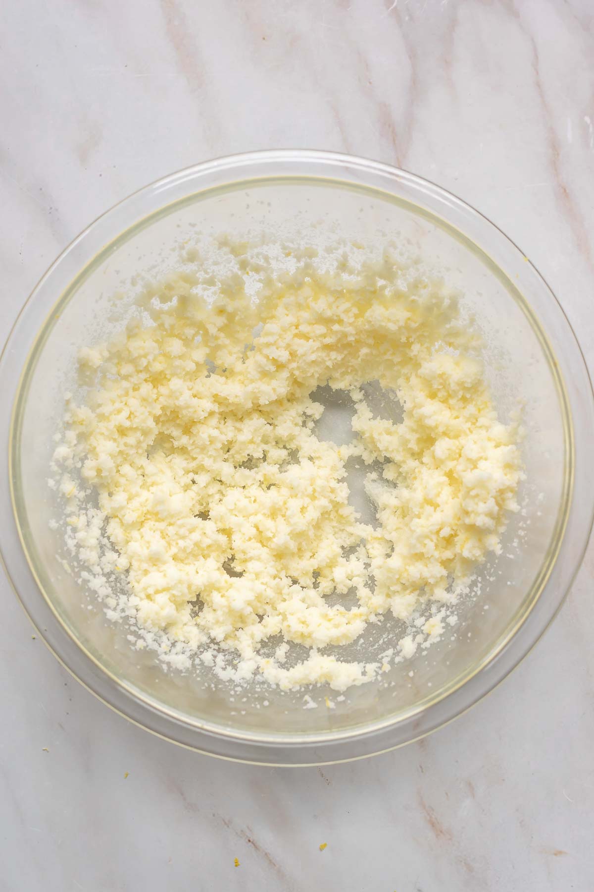 Butter and sugar creamed together in a mixing bowl.