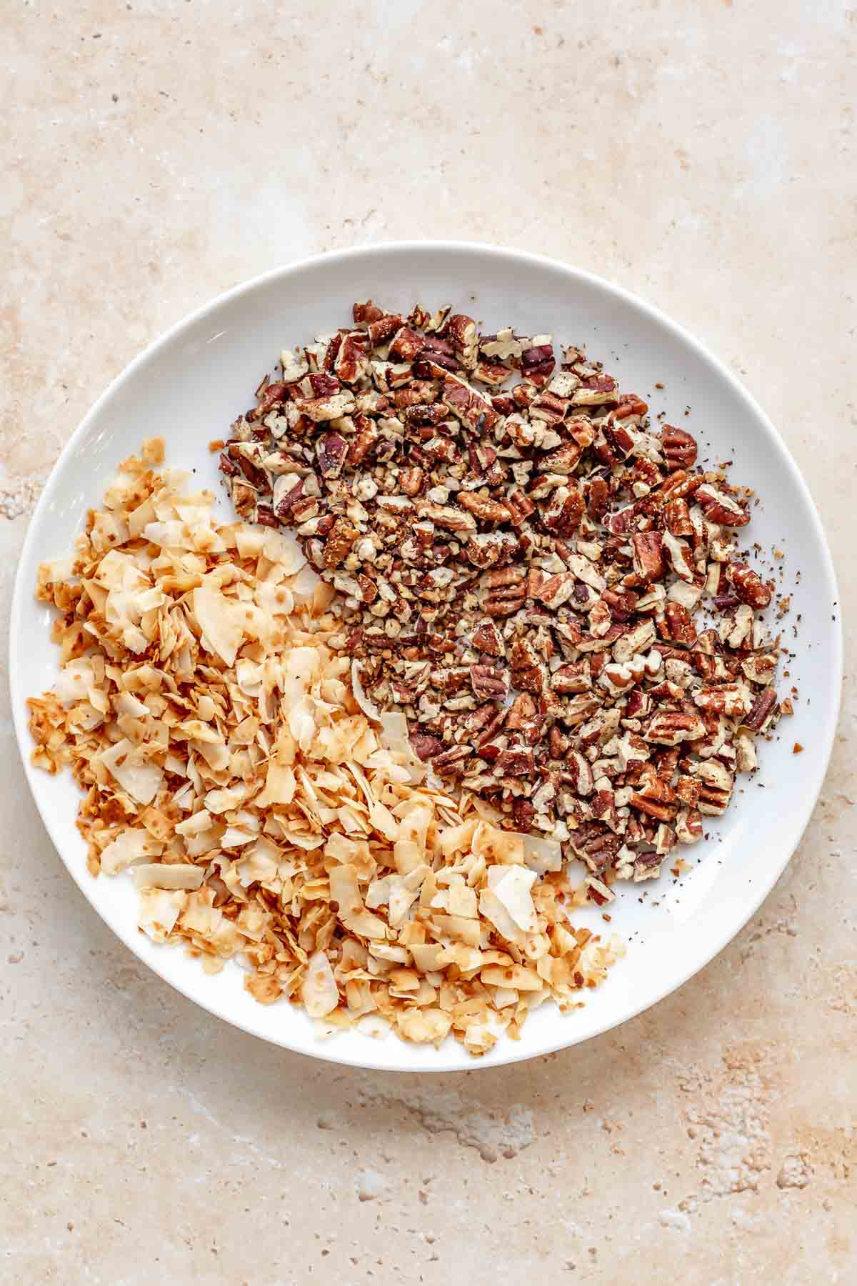 Toasted pecans and coconut in a bowl.