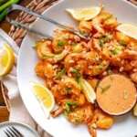 Boom boom shrimp on a platter with tongs.