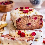 Cranberry banana bread sliced on a. cutting board.