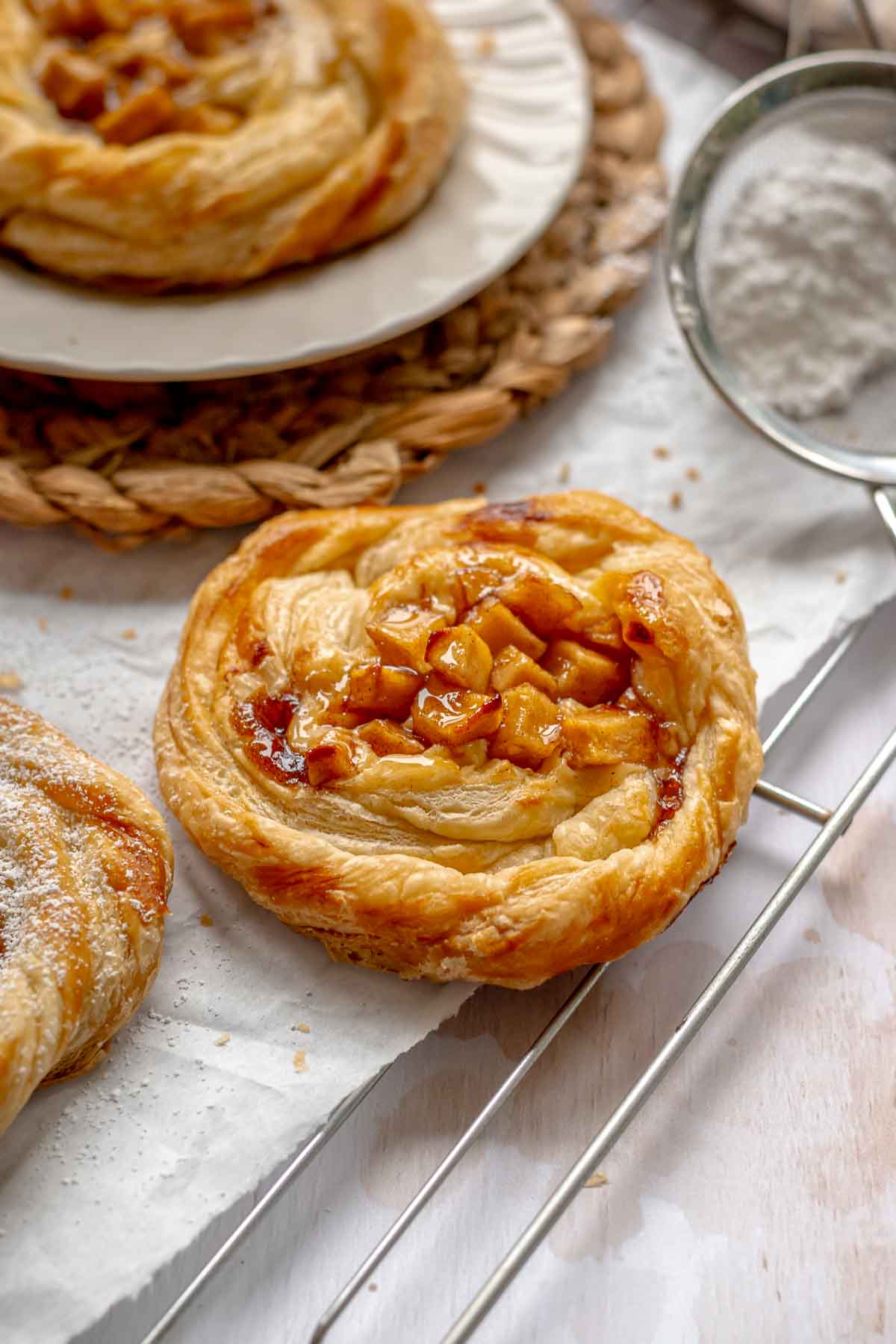 Baked apple danish on a cooling rack.