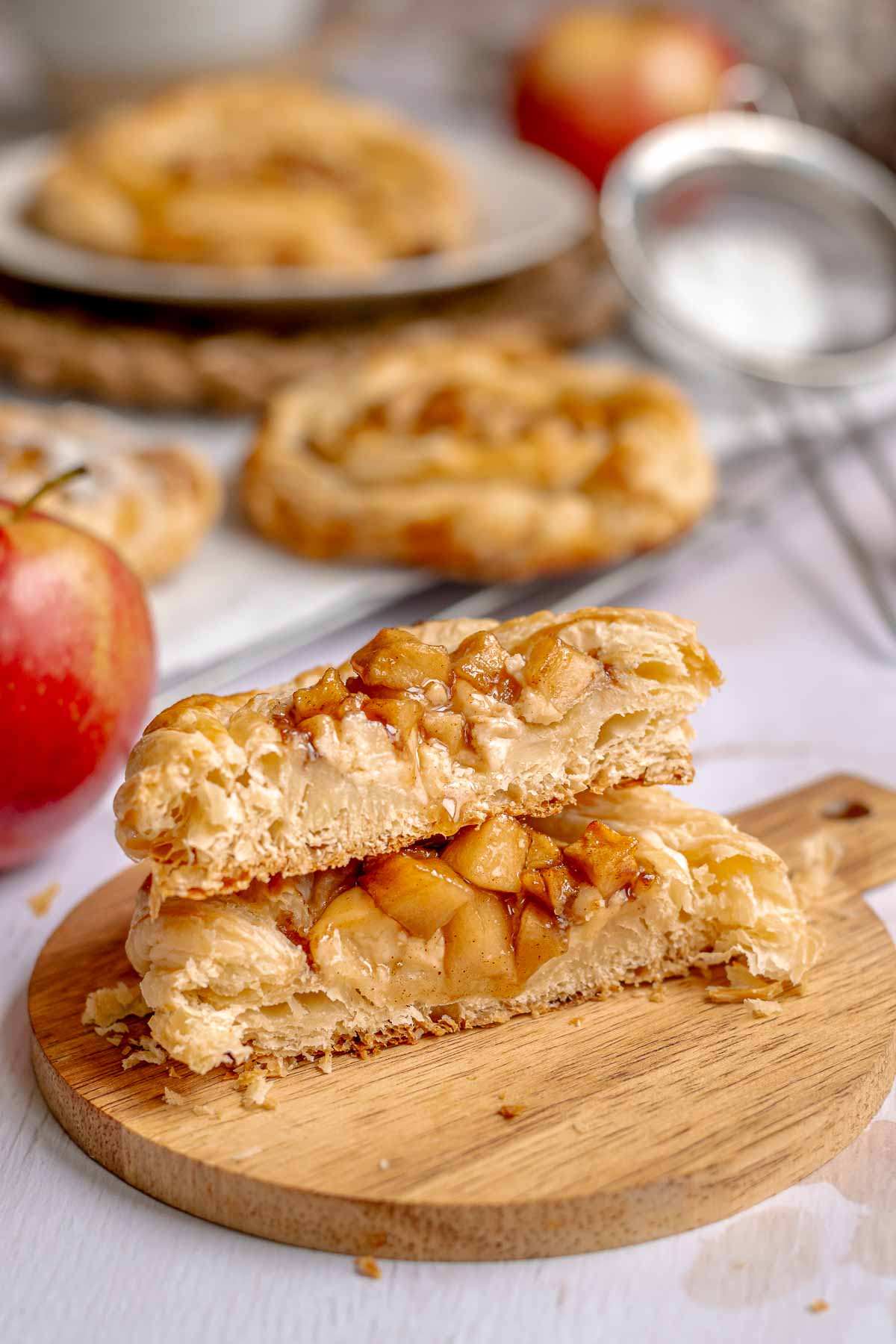 Apple danish cut in half and stacked on top of each other.