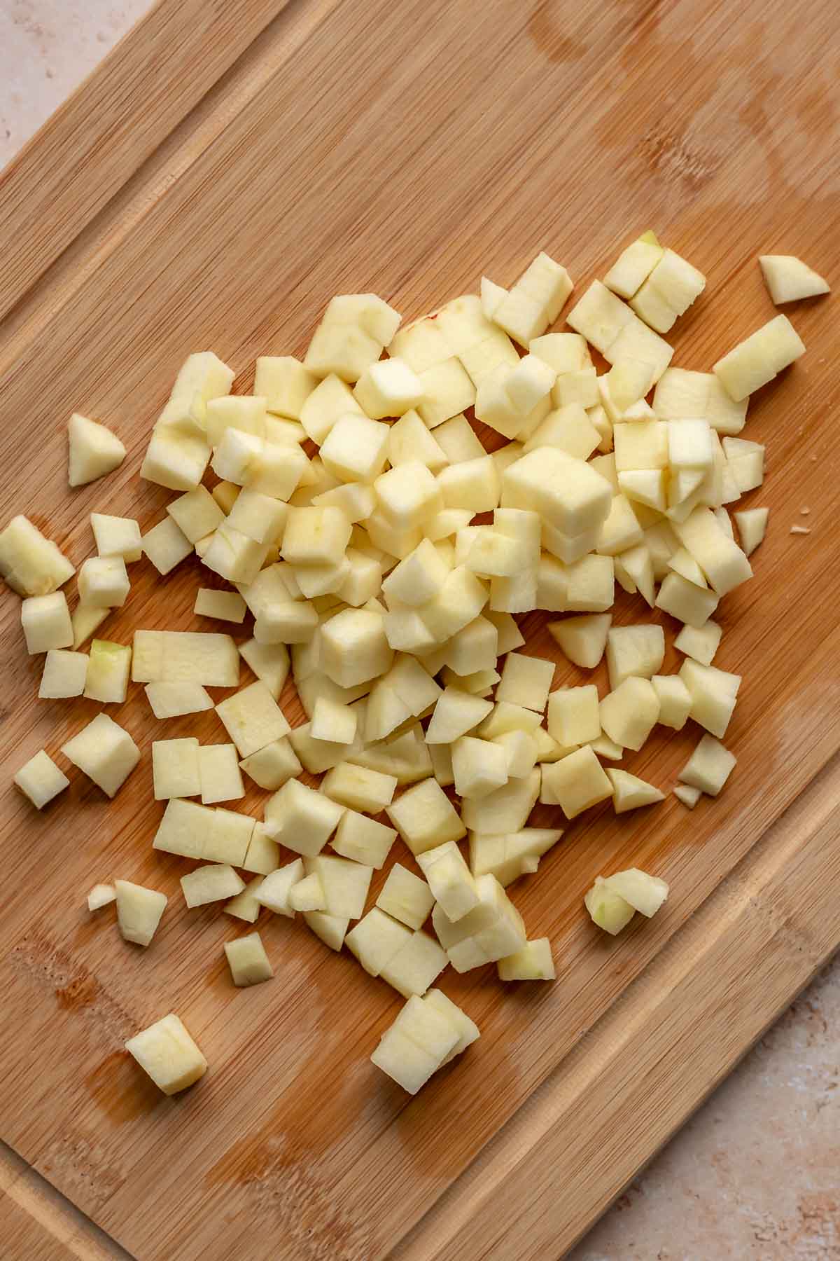 Diced apples on a cutting board.