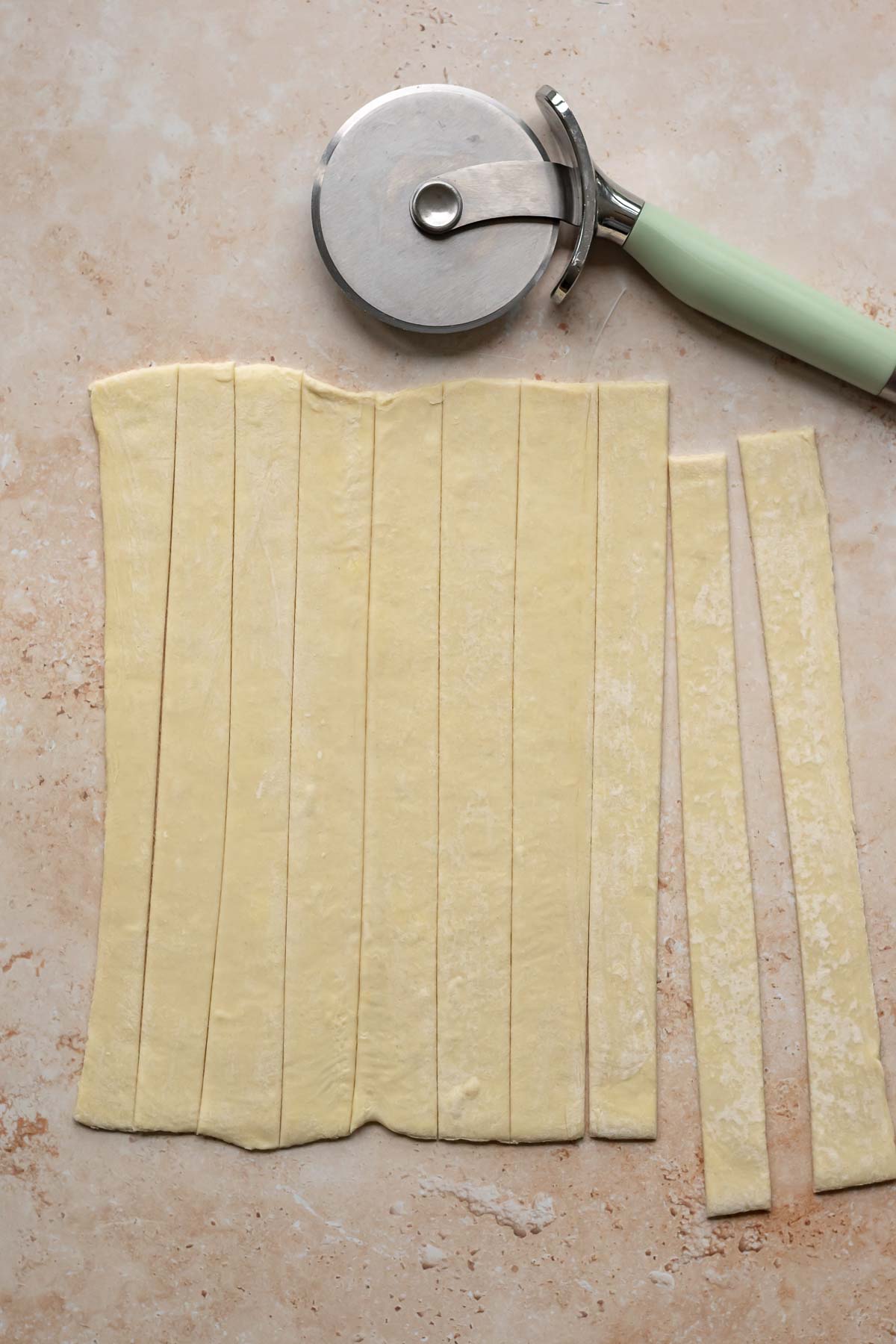 Puff pastry cut into 1" strips with a pizza wheel.