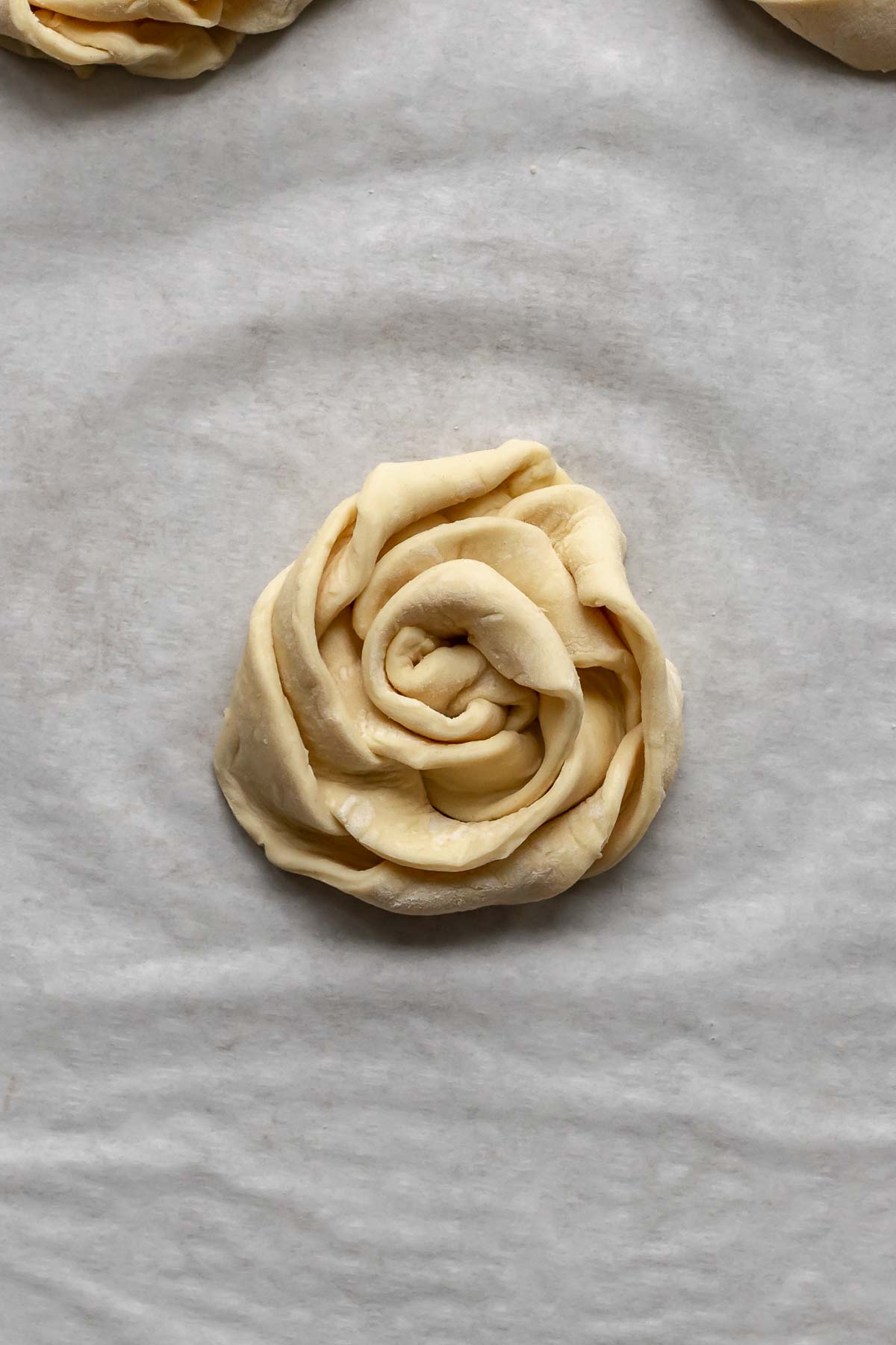 Puff pastry strips coiled into a rose.