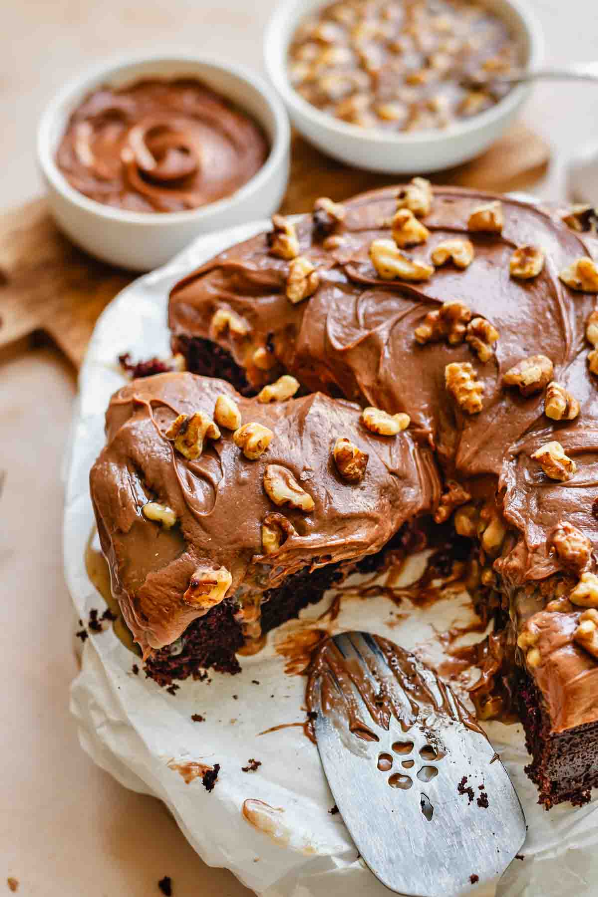 Sliced chocolate walnut cake on a platter.