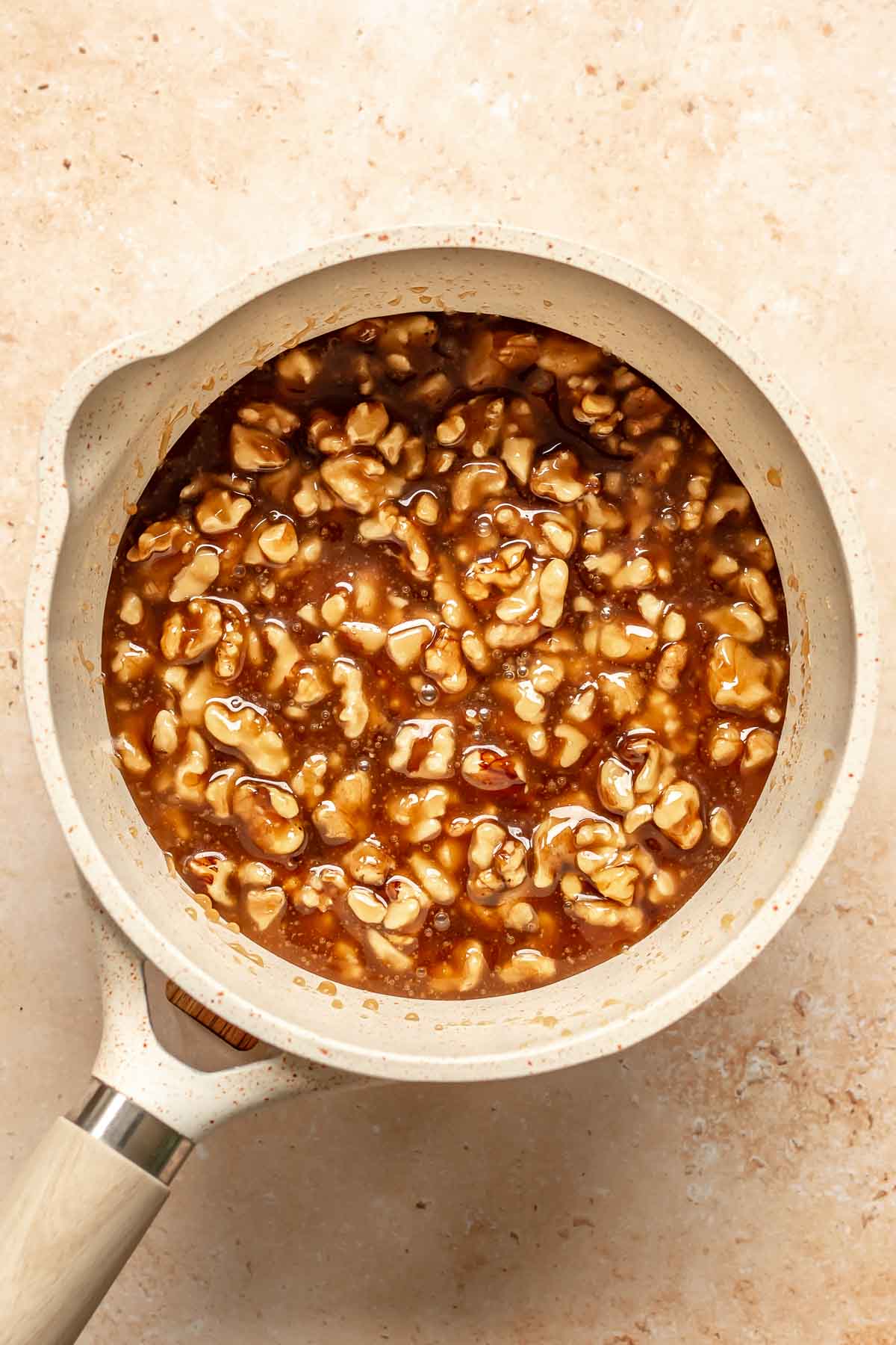 Pecans and caramel sauce in a pot.