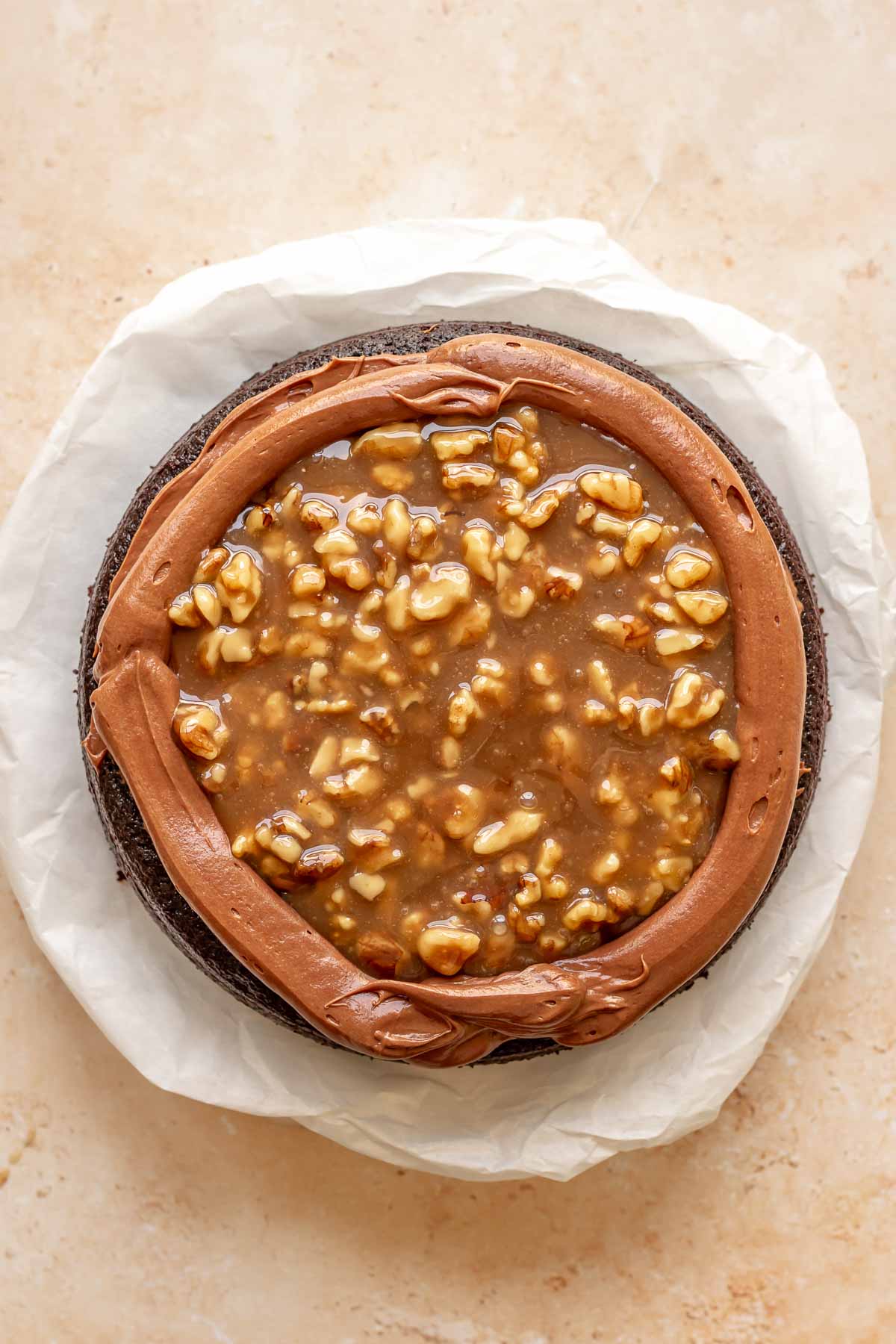 Caramel walnut filling is added to the cake.