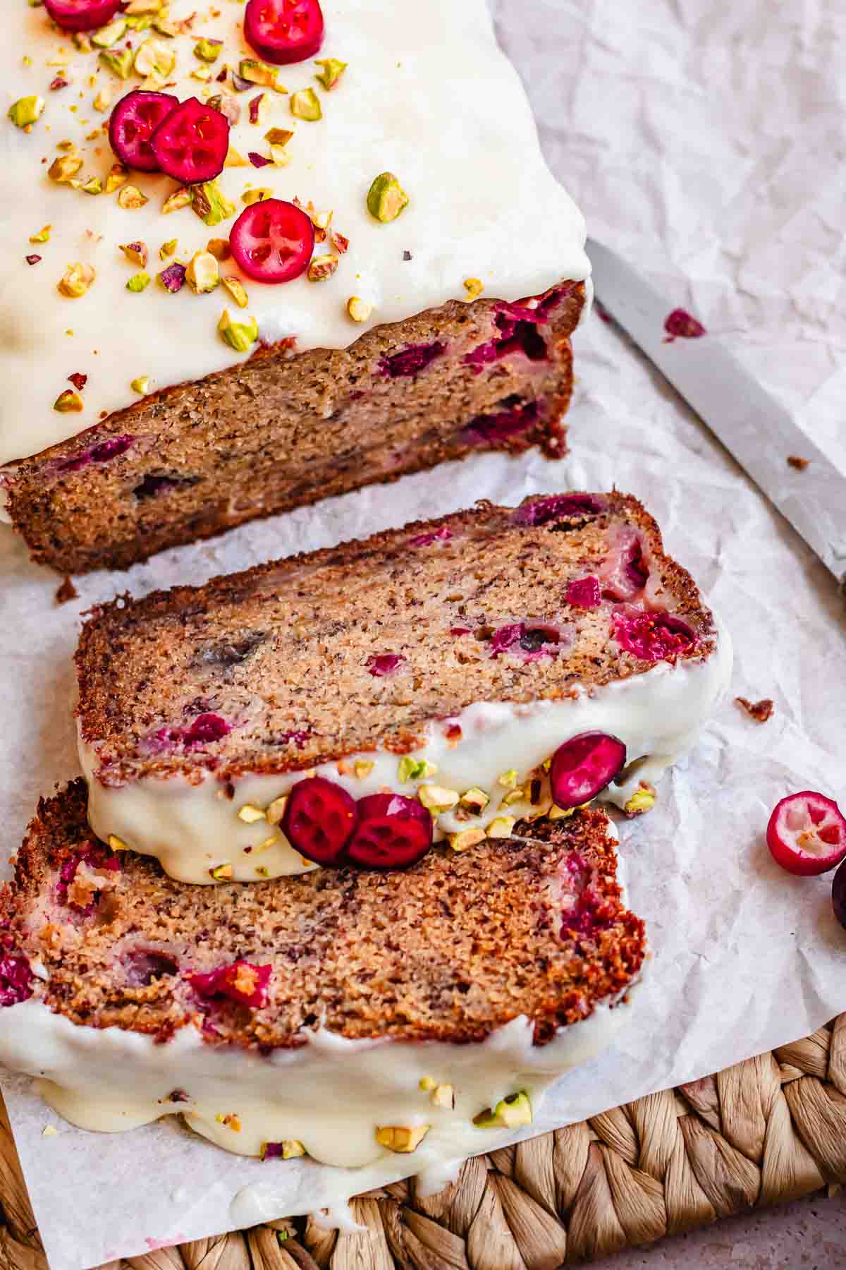 Cranberry banana bread sliced on a. cutting board.