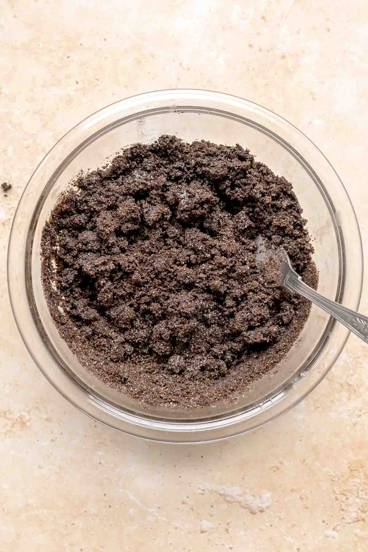Oreo crumb base mixed in a bowl with a fork.